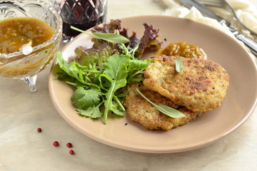 Fried pork chop with fresh herbs and fruit sauce
