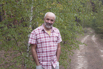 Naklejka na ściany i meble A man of mature age in the forest
