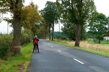 Bicycle travel. A cyclist talking on the phone on the road.