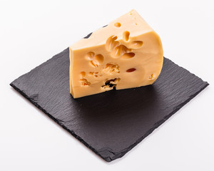 Piece and slices of cheese on a white background