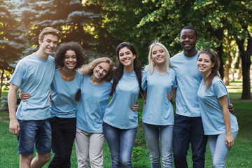 Group of young volunteers embracing at park