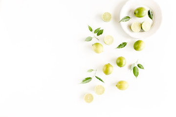 Pattern made of lime and leaves ficus. Food concept.  flat lay, top view