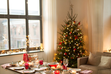 christmas, holidays and eating concept - table served for festive dinner at home