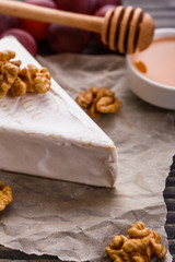 delicious creamy camembert cheese on a wooden rustic background