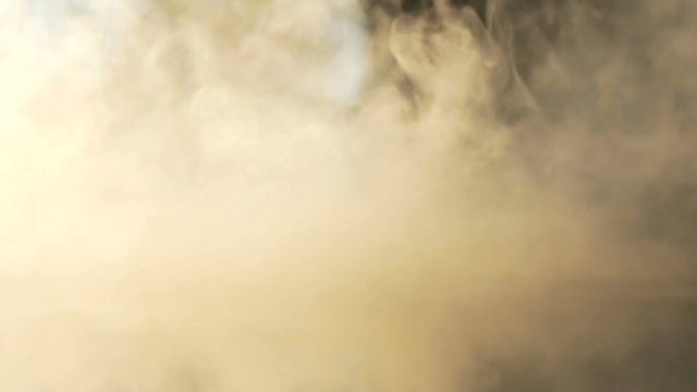 Macro shot of dense clouds of smoke and toxic vapor at camera