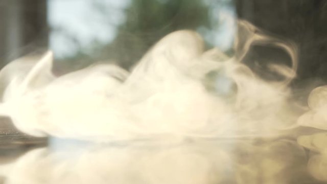 Macro shot of dense clouds of smoke and toxic vapor at camera