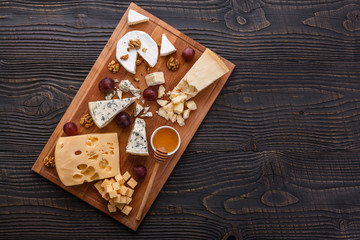 set of different cheeses on a wooden rustic background