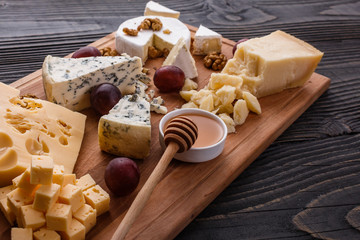 set of different cheeses on a wooden rustic background