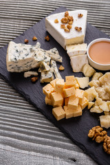 set of different cheeses on a wooden rustic background