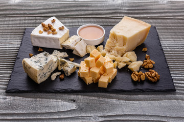 set of different cheeses on a wooden rustic background