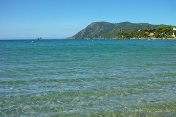 Sunny sandy beach vacation, landscape with clear blue sea shore and sandy beach