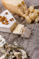 set of different cheeses on a wooden rustic background