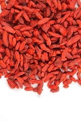 dried goji berries on a white plate food background texture with copy space