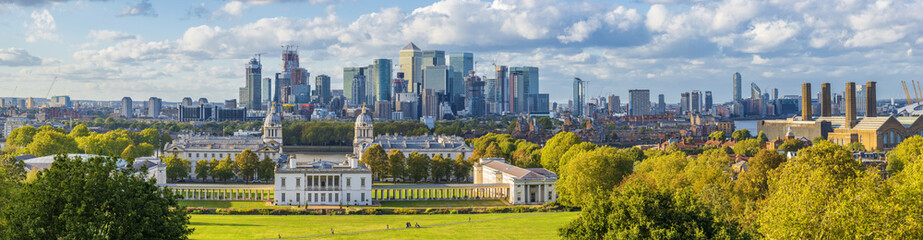 ondon, England, Panoramic Skyline View Of Greenwich College and Canary Wharf At Golden Hour Sunset With Blue Sky And Clouds - obrazy, fototapety, plakaty