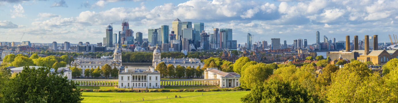 ondon, England, Panoramic Skyline View Of Greenwich College and Canary Wharf At Golden Hour Sunset With Blue Sky And Clouds