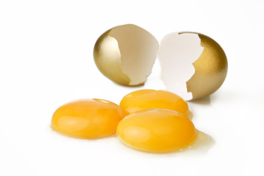 Broken Golden Egg And Three Yolks