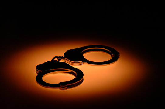 Handcuffs in orange light stain