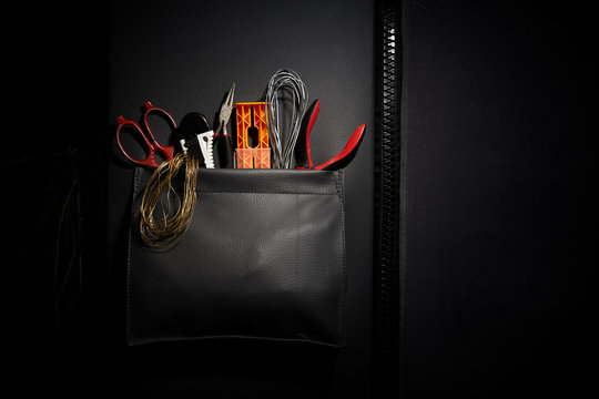 Different tools in leather pocket