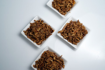 spices fried red onion in bowls on white background