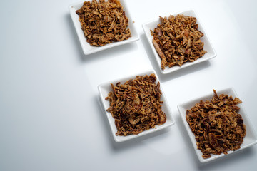 spices fried red onion in bowls on white background