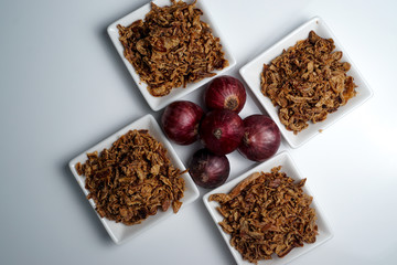 spices fried red onion in bowls on white background
