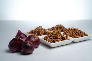 spices fried red onion in bowls on white background
