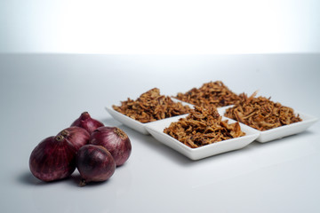 spices fried red onion in bowls on white background