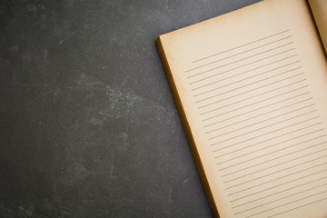 The old book on black background. Top view open old book.