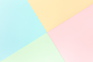 Background pastel colors: pink, yellow, blue, green. Geometric pattern papers. Minimal concept. Flat lay, Top view. 