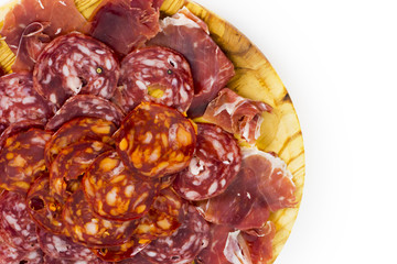 Typical spanish food with ham and sausage on a wooden plate