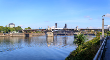 Steel bridge over water with cityscape and skyline in portland