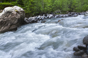 Obraz premium Mountain landscape, high mountains and stormy rivers.