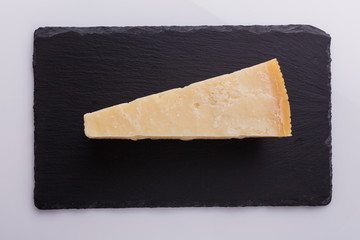 Parmesan slice on a stone slate plate