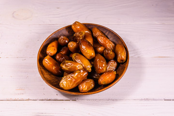 Date fruits on the white wooden table