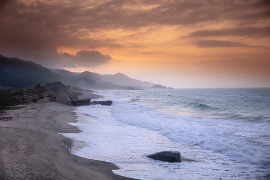 A deserted beach in Tayrona National Park under a golden sunset, Magdalena, Colombia