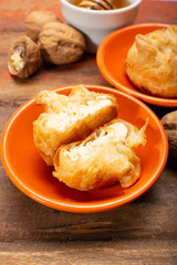 French snack pouches made from puff pastry with fresh soft goat cheese and honing