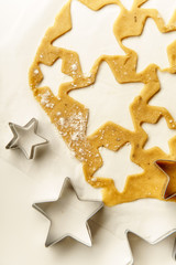 Obraz na płótnie Canvas Cooking swedish ginger cookies in a star shape, cutting. Flatlay, overhead composition. Christmas atmosphere
