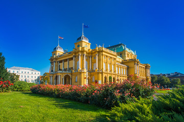 Croatian national theater building and flowers in park in Zagreb, Croatia