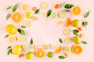 Frame made of summer tropical fruits: orange, lemon, lime, mango on pink background. Food concept. flat lay, top view