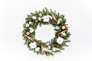 Wreath from fir, pine and spruce twigs, decorated with cotton, eucalyptus, cinnamon, isolated on white background
