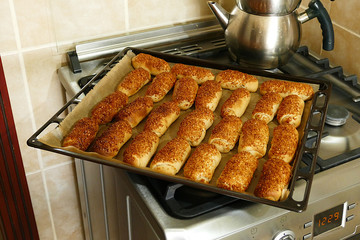 made a fresh sesame bagel in a woman's oven, homemade pastries,
