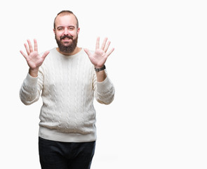 Young caucasian hipster man wearing winter sweater over isolated background showing and pointing up with fingers number ten while smiling confident and happy.