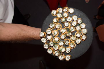 small appetizers on the arm of a waiter