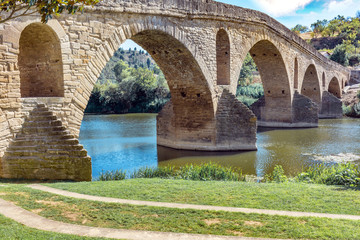 Ancient roman bridge across the Arga river in Puente la Reina, near Pamplona, Navarra, Spain