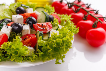Greek salad on a white acrylic background