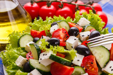 Greek salad on a wooden rustic background
