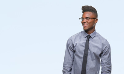 Young african american business man over isolated background looking away to side with smile on face, natural expression. Laughing confident.
