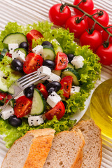 Greek salad on a wooden rustic background