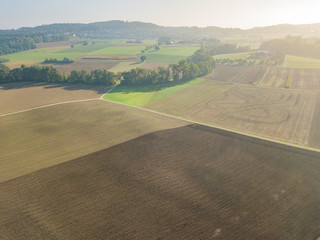 Fototapeta na wymiar Aerial view of plowed fields in rural landscape in Switzerland
