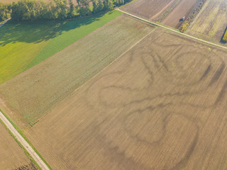 Obraz premium Aerial view of plowed fields in rural landscape in Switzerland